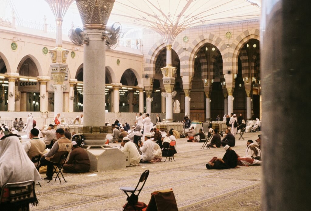 Admissions (process) Pilgrims in prayer at Al-Masjid an-Nabawi, showcasing Islamic architecture.